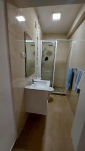 a bathroom with a sink and a shower at Apartamento F3, Lazareto - Mindelo in Mindelo