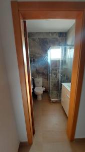 a small bathroom with a toilet and a sink at Apartamento F3, Lazareto - Mindelo in Mindelo