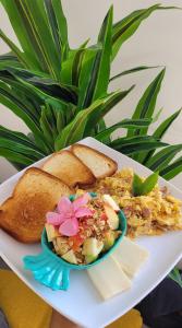 a plate of food with a plate of food with bread at Colorful Garden House in Providencia +76 photos