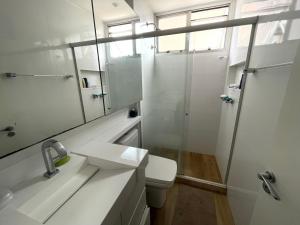 a bathroom with a shower and a toilet and a sink at Duas Suítes e o Cristo Redentor in Rio de Janeiro