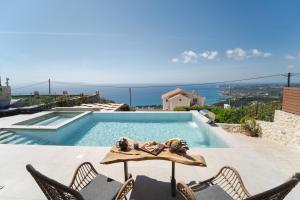 a villa with a swimming pool with a view of the ocean at Kefalonia Heaven Villa in Vlachata