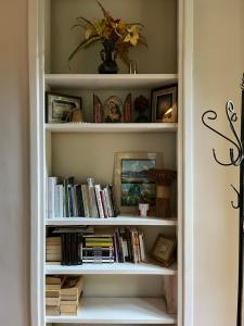 a book shelf filled with books in a room at Willa Starówka in Nałęczów +2 photos