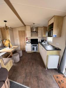 a small kitchen with a sink and a stove at N and B caravan hire Flamingo Land in Kirby Misperton