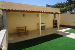 a patio with a picnic table and a bench at Sunny Home in Amadora