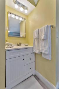 a bathroom with a sink and a mirror at Sea Gem One bed one bath charmer steps to beach in Bradenton Beach