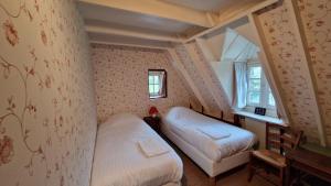 Posteľ alebo postele v izbe v ubytovaní La Grange du Moulin de Lossulien