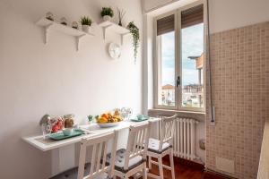 a kitchen with a table and chairs and a window at B&B della Stazione in San Severo