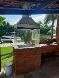 a large terrarium with a grill on a patio at Casa Marina Guarujá in Guarujá