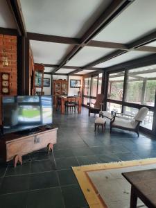 a living room with a large flat screen tv at Casa Marina Guarujá in Guarujá