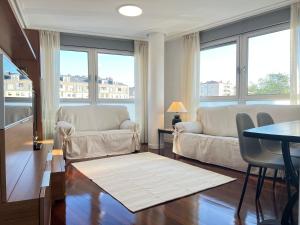 a living room with two couches and a table at Exclusivo Apartamento Con Parking in Torrelavega