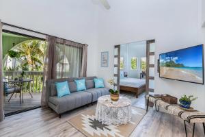 a living room with a couch and a tv at Kamahana 16 - up in Princeville