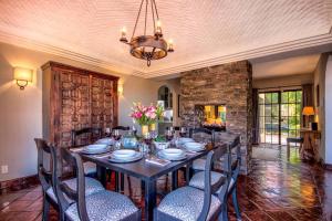 a dining room with a long table and chairs at ELEGANT HOME WITH STUNNING VISTAS - CASA VALENTINA in San Miguel de Allende