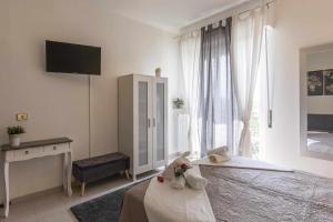 a white bedroom with a bed and a window at Destiny home 1 verona borgo trento appartamento in Verona +9 photos