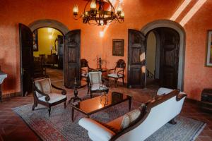 a living room filled with furniture and a chandelier at Casa Don Pascual Hotel Boutique Sweet Home in San Miguel de Allende