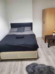 a bedroom with a large bed and a table at Four bedroom property for 10 guests, great location Aldgate E1 close to Tower bridge in London