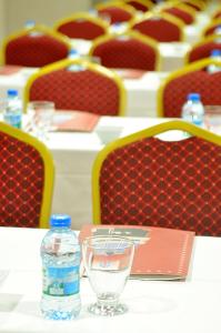 a table with a bottle of water and a glass at Starton Hotel in Ankara