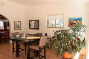 a dining room with a black table and chairs at Peaceful Santa Fe Forest Home, Comfy and Well-equipped in Santa Fe