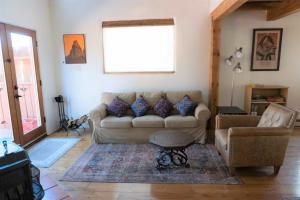 a living room with a couch and a chair at Peaceful Santa Fe Forest Home, Comfy and Well-equipped in Santa Fe