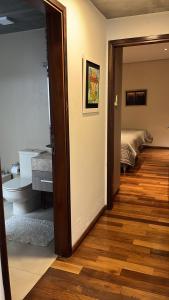 a room with a bathroom with a toilet and a bedroom at Madre Natura in Asunción