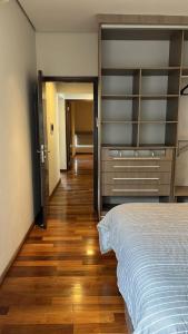 a bedroom with a bed and a wooden floor at Madre Natura in Asuncion