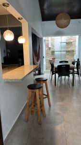 a dining room with wooden stools and a table at Madre Natura in Asuncion
