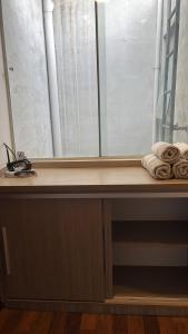 a window sill with towels on it next to a window at Madre Natura in Asuncion