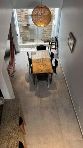 a dining room with a wooden table and chairs at Madre Natura in Asuncion