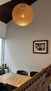 a dining room with a table and a chandelier at Madre Natura in Asuncion