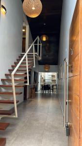 a hallway with stairs and a dining room with a table at Madre Natura in Asuncion