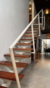 a white staircase in a room with a table at Madre Natura in Asuncion
