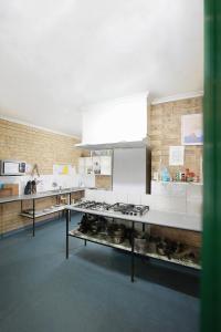 a kitchen with a stove and a counter top at Coolum Budget Accommodation in Coolum Beach