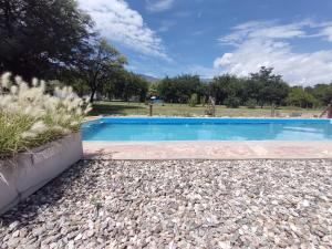 a swimming pool in a gravel yard with a blue at Cielos Abiertos in La Paz