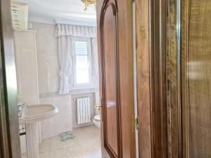 a bathroom with a toilet and a sink at Spacious house with pool and garden in Congosto in Congosto +50 photos
