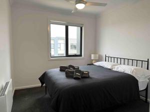 a bedroom with a bed with a ceiling fan at Wonderful Jubilee Estate House in Wyndham Vale