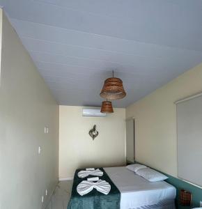 a bedroom with a bed with towels on it at Green Village pousada Atins in Atins