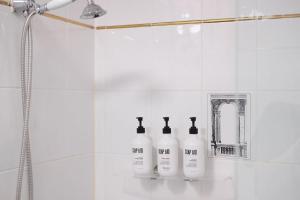 a group of three bottles sitting on a shelf in a bathroom at Ciao Bella in Brisbane +21 photos