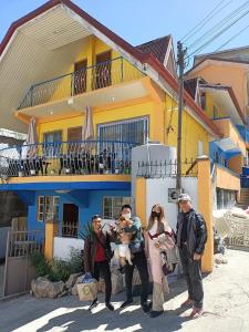 a group of people standing in front of a house at Baguio Camella Big Brother House in Baguio