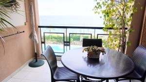 a table and chairs in a room with a pool at Appartement 556, Vue Mer et piscine By Palmazur Vacances in Cannes