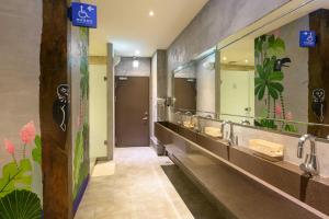 a bathroom with two sinks and a large mirror at WORK INN at Taipei 101 in Taipei