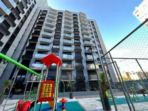 a playground in front of a tall apartment building at Brand New apartment near port - piso 11 in Montevideo