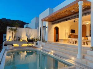 a villa with a swimming pool and a house at Villa Soll A By The Villas 100 in Bogor