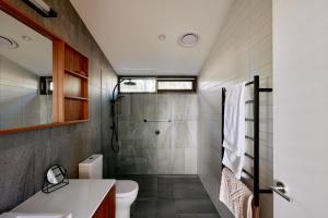a bathroom with a shower and a toilet and a sink at Luxury Ocean View house Saltbush Farm in Cape Jervis +26 photos