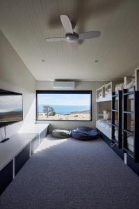 a room with two beds and a large window at Luxury Ocean View house Saltbush Farm in Cape Jervis