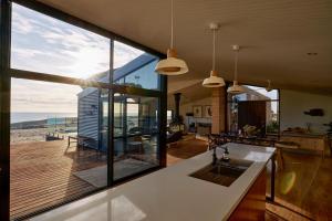 an open kitchen with a view of the ocean at Luxury Ocean View house Saltbush Farm in Cape Jervis