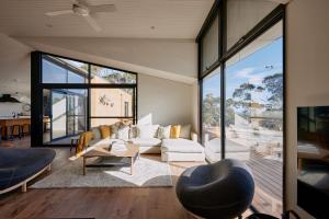 a living room with a couch and a table at Luxury Ocean View house Saltbush Farm in Cape Jervis