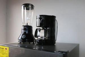 a black blender sitting on top of a refrigerator at Aparta Suite Torre De Prado Penthouse in Medellín