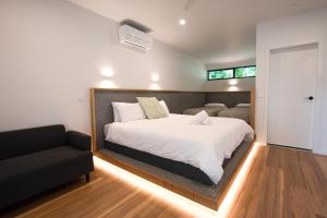 a bedroom with a large bed and a couch at Harrietville Hotel Motel in Harrietville +71 photos