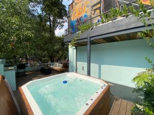 a hot tub on a patio next to a building at Casa en corazón de la colonia roma Jacuzzi in Mexico City