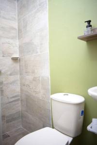W łazience znajduje się biała toaleta i prysznic. w obiekcie casa nogal w mieście Medellín