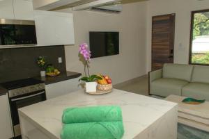 a kitchen with a table with a green towel on it at Casa Kaiman - Apartment Rincon in Nosara
